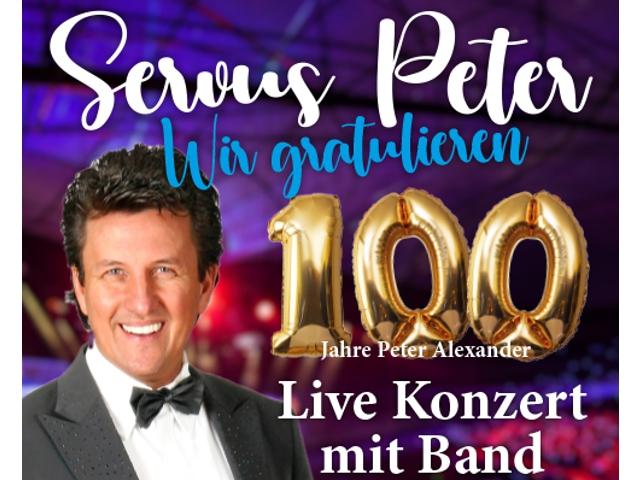 Das Foto zeigt einen Mann, der seinen 100. Geburtstag feiert und dabei Anzug und Krawatte trägt.